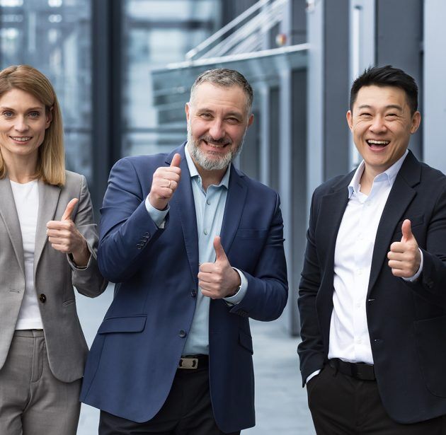 Cheerful dream team, senior and experienced IT professionals in business suits smiling and happy holding thumb up and looking at camera, diverse group of project managers outside office building Cheerful dream team, senior and experienced IT professionals in business suits smiling and happy holding thumb up and looking at camera, diverse group of project managers outside office building.